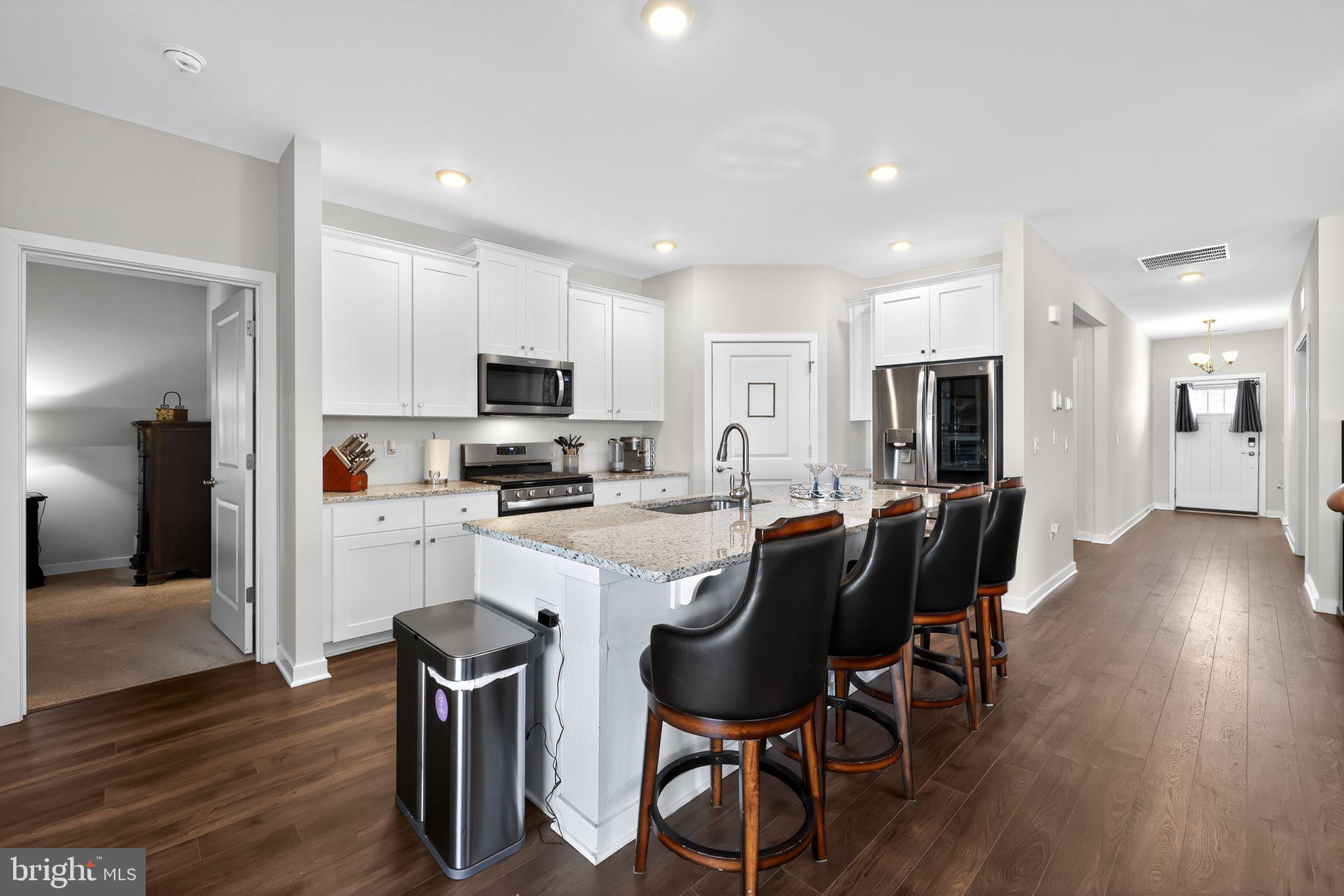 103 Congressional Court Moorestown, NJ 08057 - Photo 12 of 31 a kitchen with stainless steel appliances granite countertop a table chairs refrigerator and a stove top oven