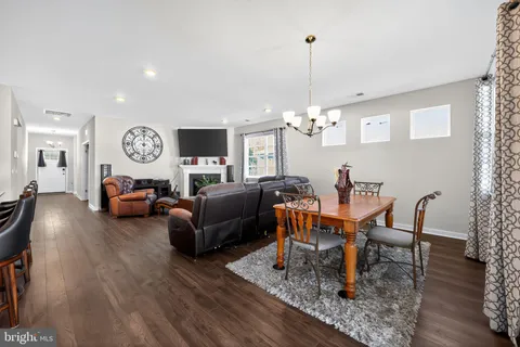 a living room with furniture a rug and a chandelier