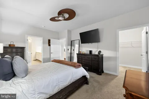 a bedroom with a bed and a television