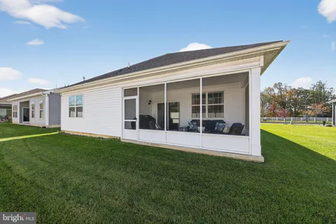 a view of an house with backyard space and balcony