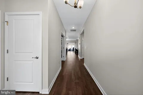a view of a hallway with a dining room