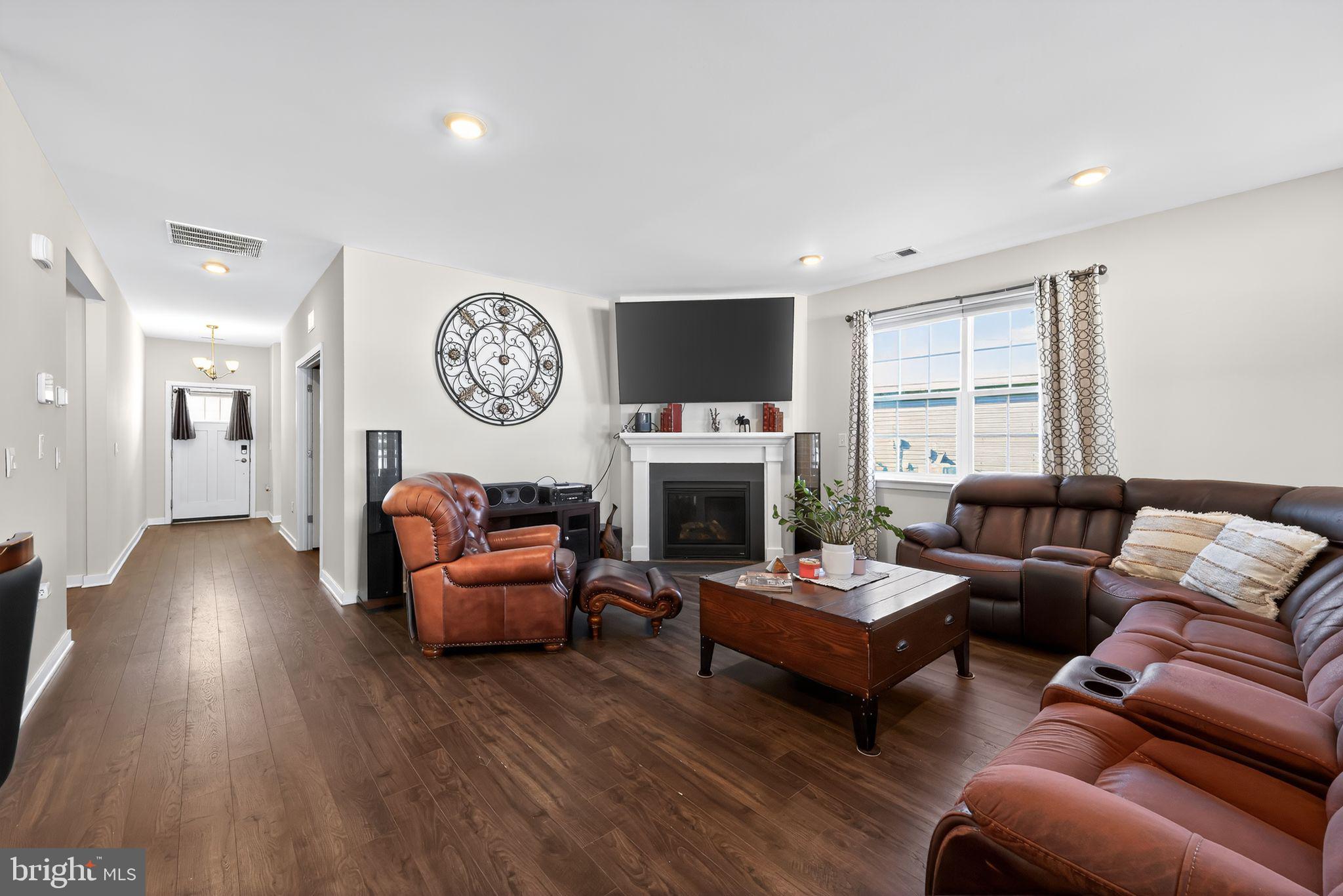 103 Congressional Court Moorestown, NJ 08057 - Photo 4 of 31 a living room with furniture a fireplace and a flat screen tv