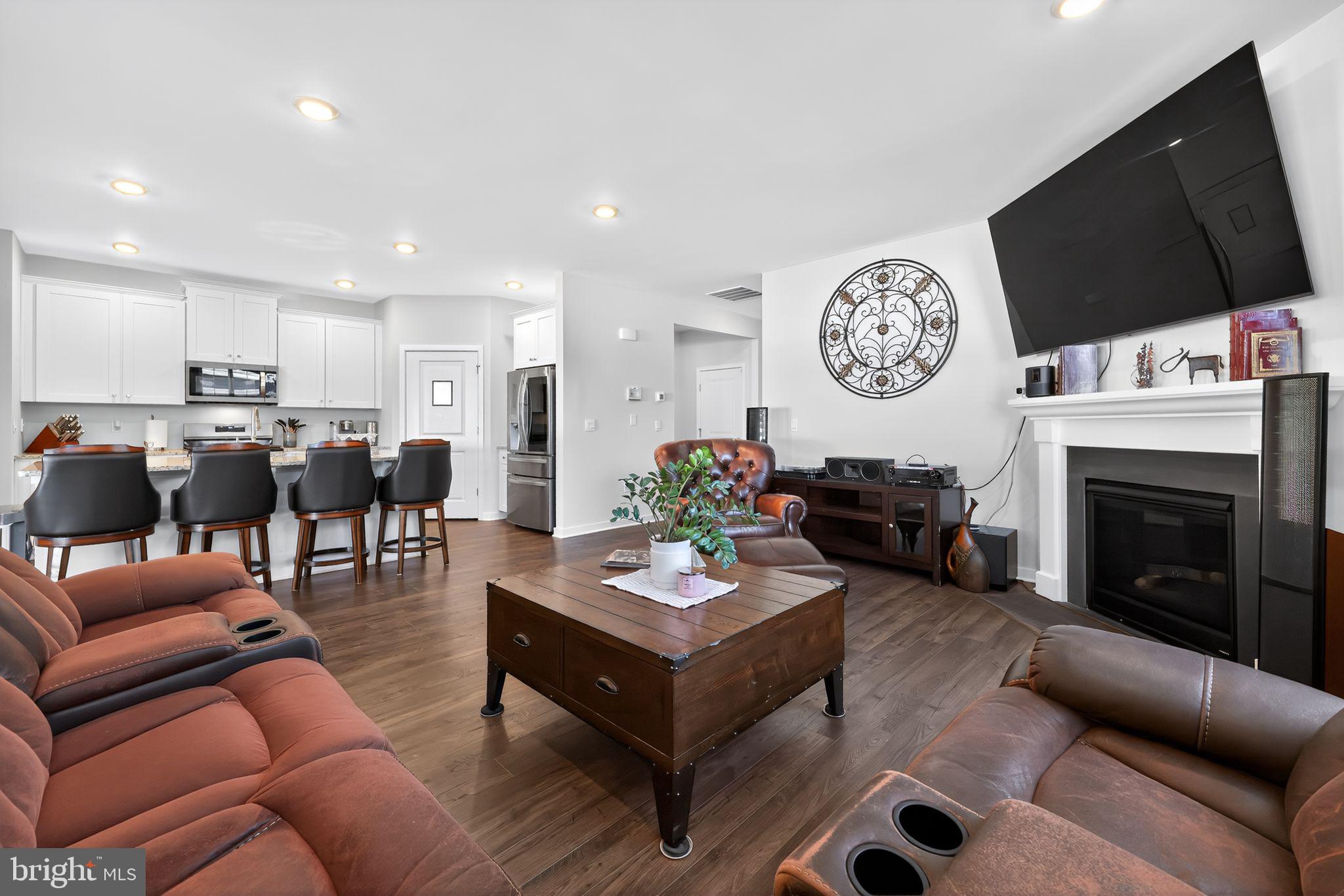 103 Congressional Court Moorestown, NJ 08057 - Photo 5 of 31 a living room with furniture a flat screen tv and kitchen view