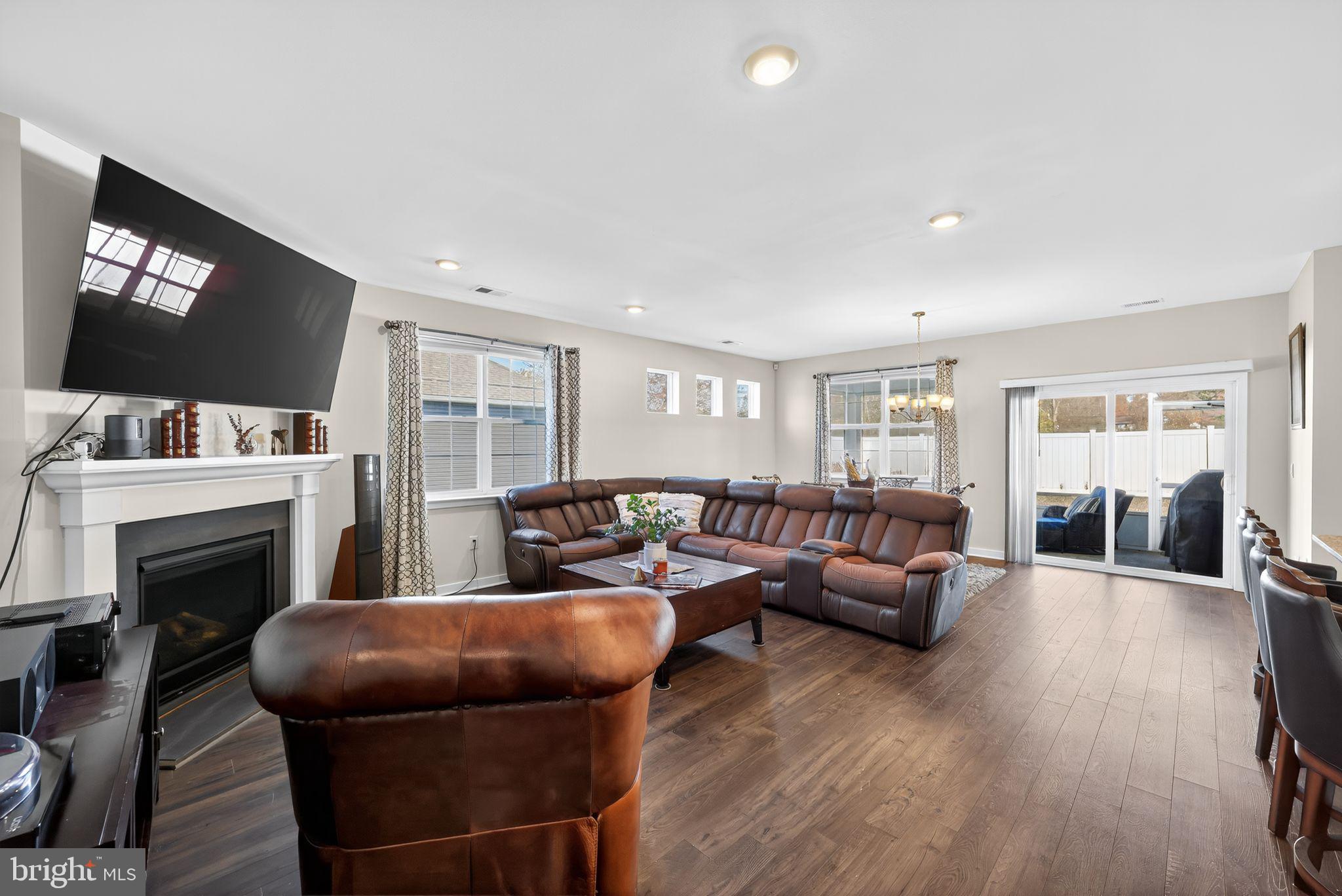 103 Congressional Court Moorestown, NJ 08057 - Photo 6 of 31 a living room with furniture a flat screen tv and a fireplace