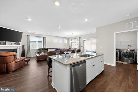 a open kitchen with sink cabinets and wooden floor