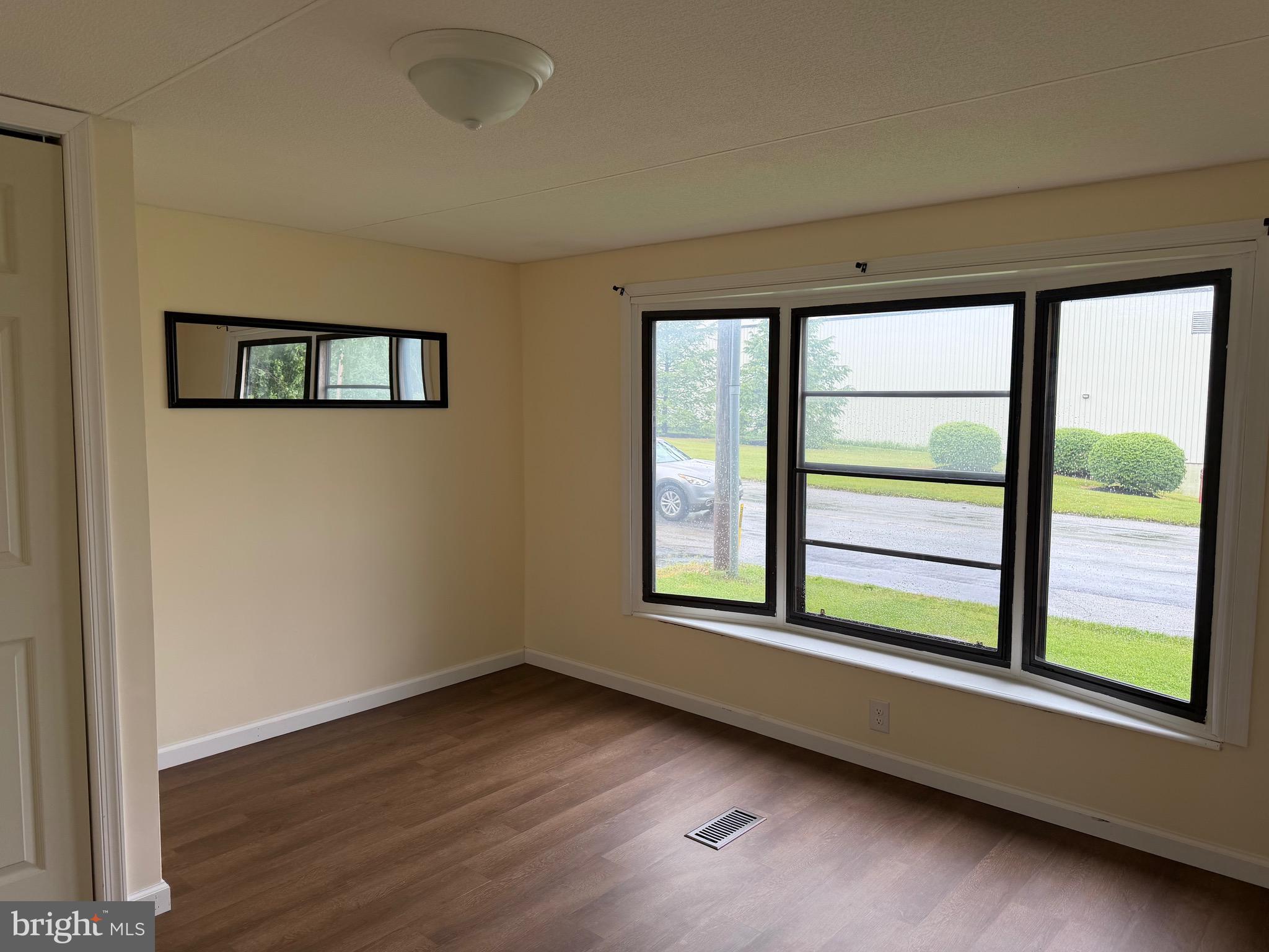 1104 West Elm Avenue Hanover, PA 17331 - Photo 8 of 13 an empty room with wooden floor and windows