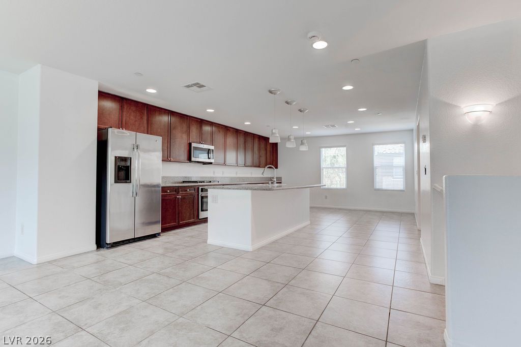 4650 Ranch House Road, Unit 47 North Las Vegas, NV 89031 - Photo 3 of 43 A contemporary kitchen and open-concept living area with sleek cabinetry and a spacious island.