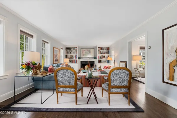 a kitchen with stainless steel appliances granite countertop a table and chairs in it