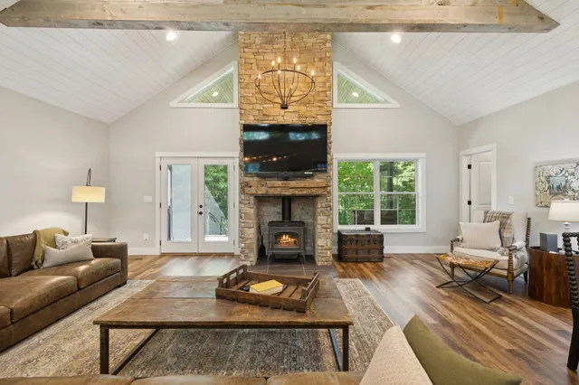 a living room with fireplace furniture and a chandelier