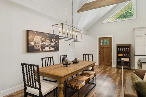 a kitchen with kitchen island a large counter space a sink appliances and a window