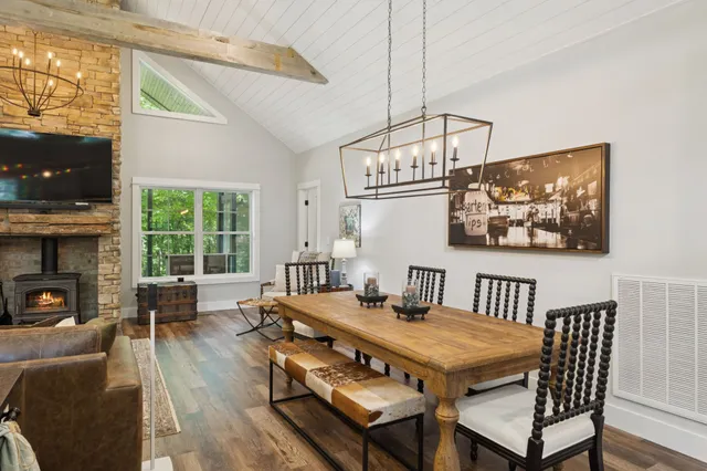 a kitchen with stainless steel appliances a kitchen island hardwood floor and a window