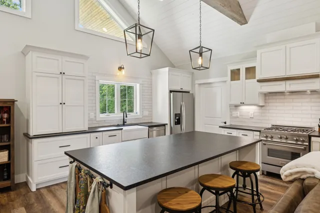 a bedroom with a bed and a large window with outer view