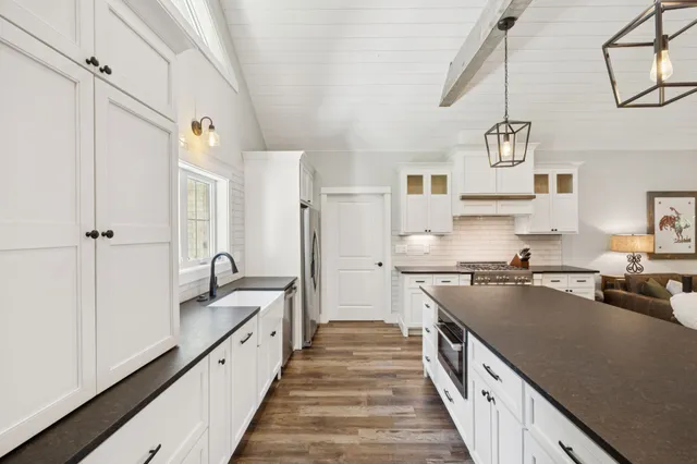 a bathroom with a granite countertop sink a toilet and shower