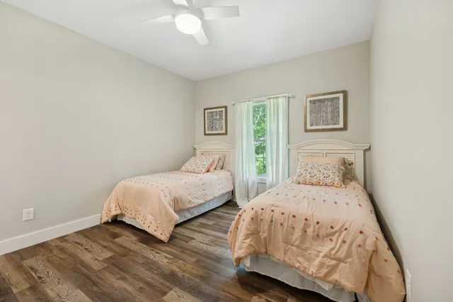 an aerial view of residential houses with outdoor space and trees