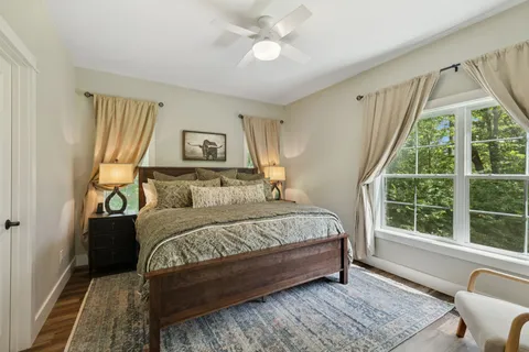 an aerial view of residential houses with outdoor space and trees