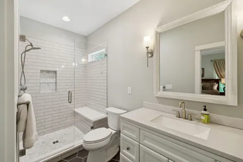 a view of a lush green forest with trees and some houses