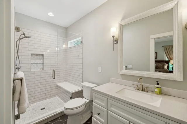 a view of a lush green forest with trees and some houses