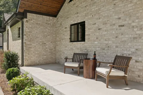 a living room with furniture a fireplace and a floor to ceiling window