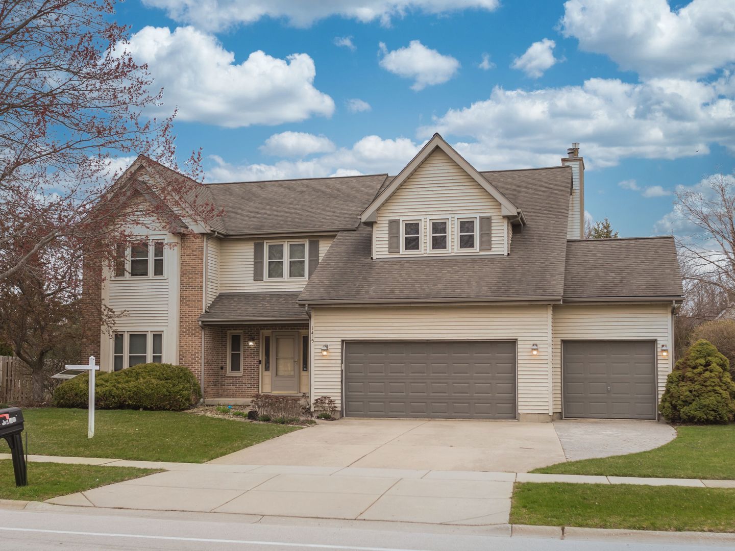 1415 Stonegate Road Algonquin, IL 60102 - Photo 1 of 49 a front view of a house with a yard and garage