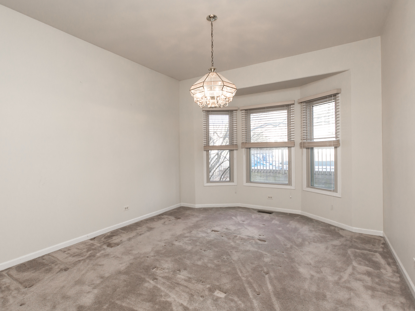 1415 Stonegate Road Algonquin, IL 60102 - Photo 7 of 49 a big room with windows and chandelier