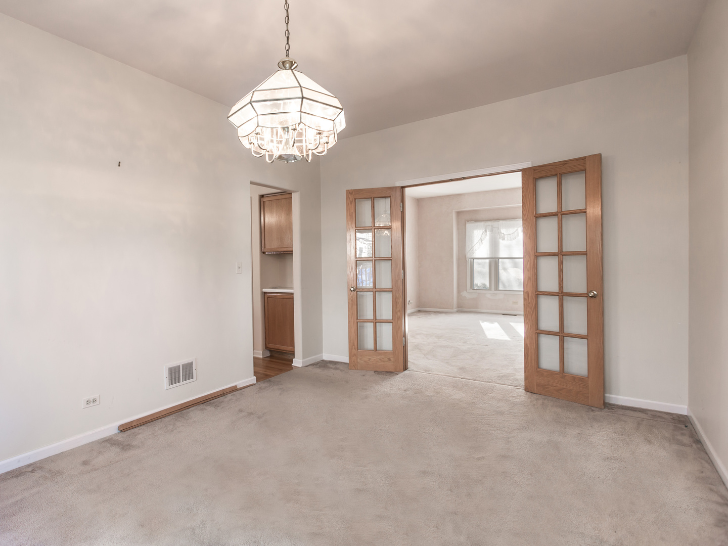 1415 Stonegate Road Algonquin, IL 60102 - Photo 8 of 49 an empty room with chandelier fan and windows