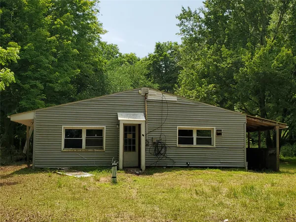a house with trees in the background