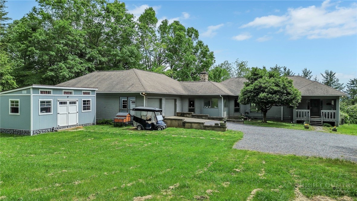 a view of a house with a yard and sitting area