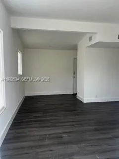 a view of a room with wooden floor