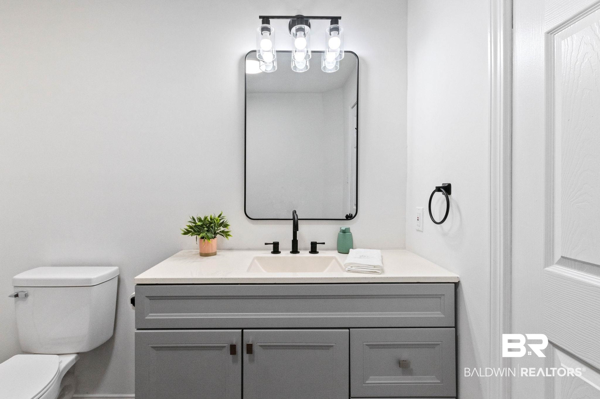 128 Bush Avenue Mobile, AL 36604 - Photo 33 of 40 Half bathroom with toilet and vanity