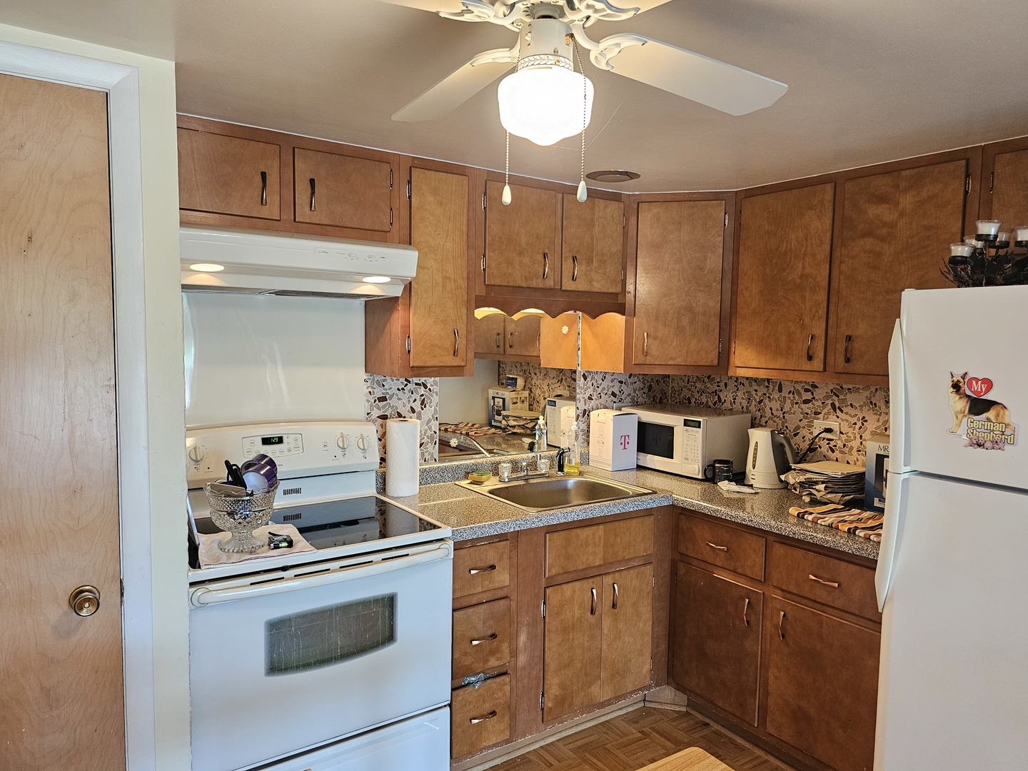 127 North Wolf Road, Unit 57B Wheeling, IL 60090 - Photo 3 of 18 a kitchen with a sink stove and refrigerator