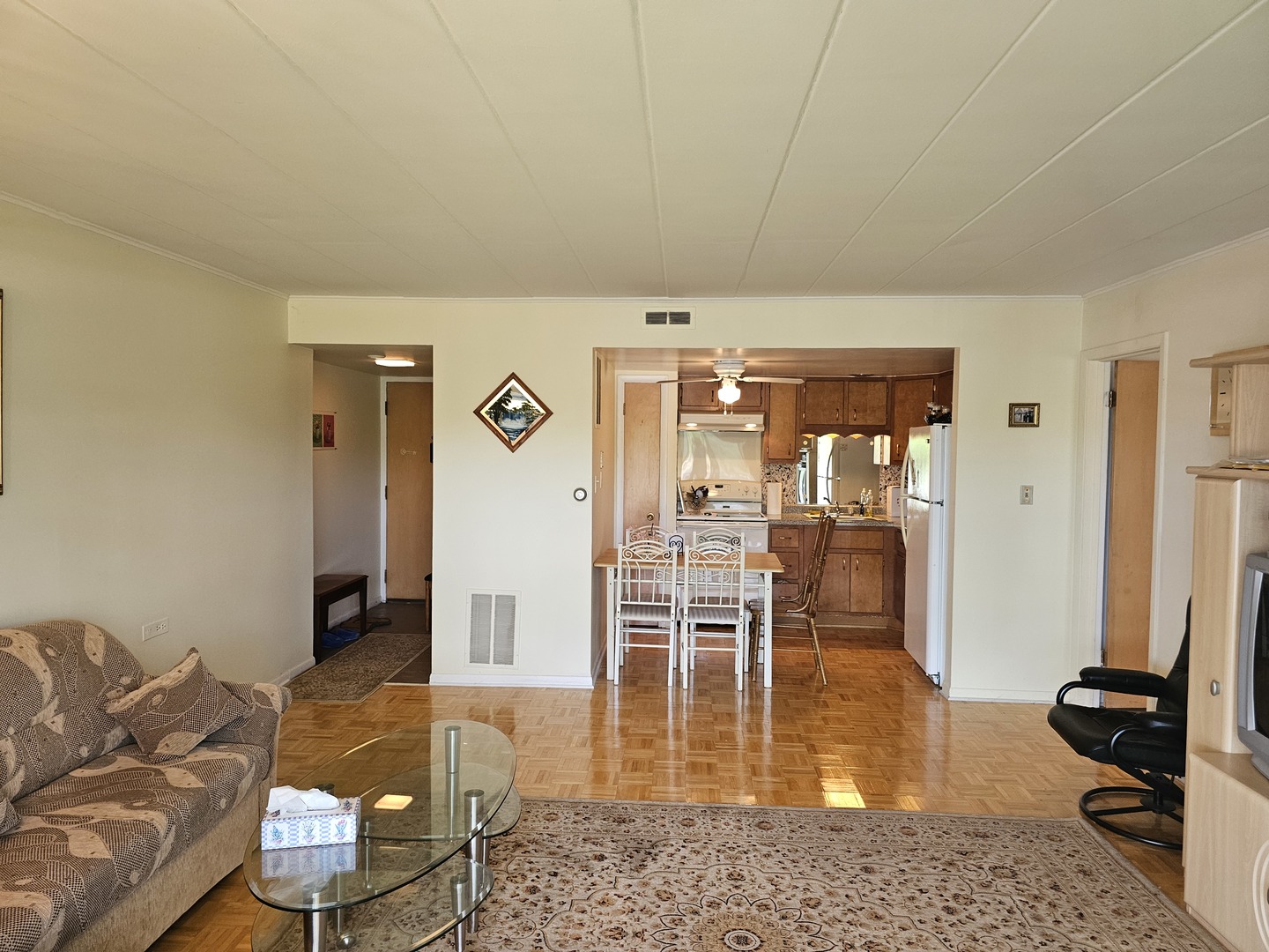 127 North Wolf Road, Unit 57B Wheeling, IL 60090 - Photo 7 of 18 a living room with furniture rug and a table
