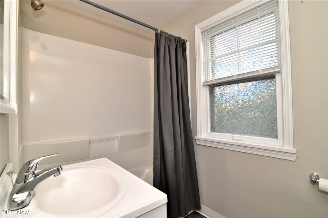1443 Churchill Road Lyndhurst, OH 44124 - Photo 29 of 39 Bathroom with shower / bath combination with curtain and vanity