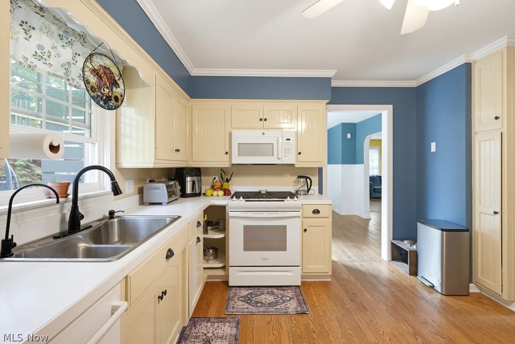 149 North Medina Line Road Akron, OH 44333 - Photo 7 of 42 White appliances, light-toned cabinetry, wood-finish flooring, a double-basin stainless steel sink, and a multi-speed ceiling fan