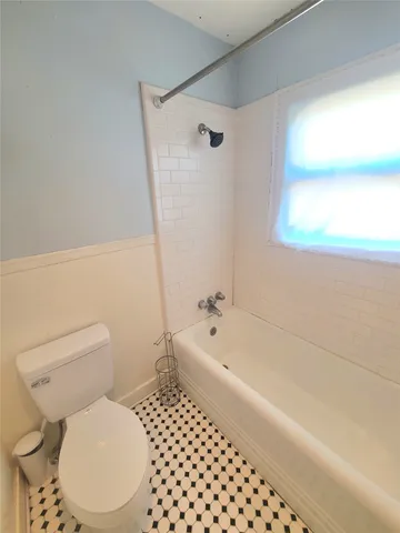 a bathroom with a toilet a sink and bathtub