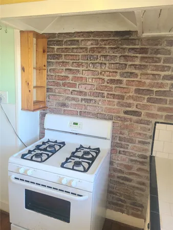 a white stove top oven sitting inside of a kitchen