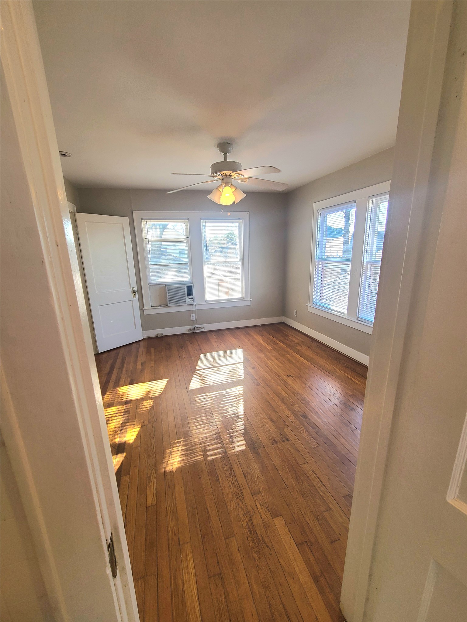 1827 Fourcade Street Houston, TX 77023 - Photo 9 of 16 wooden floor in an empty room with a window