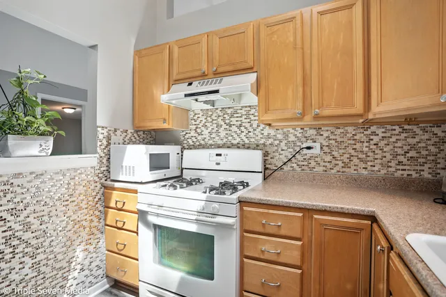 a kitchen with a stove and cabinets