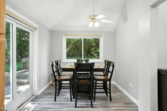 a view of a dining room with furniture wooden floor and chandelier