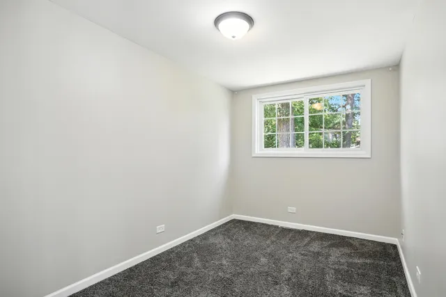 an aerial view of a residential houses with outdoor space and street view