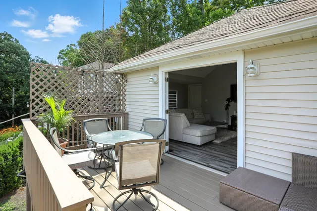 a view of a chairs and table on the roof deck