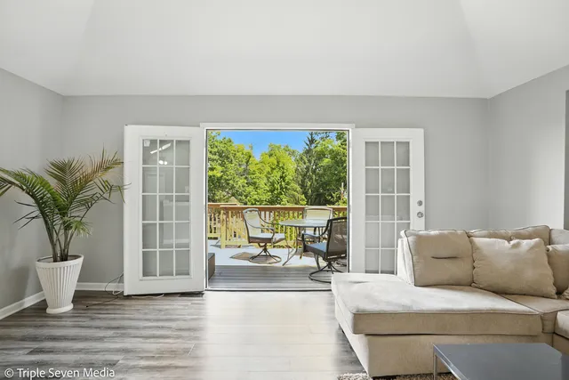 a living room with furniture and large windows