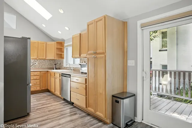 a kitchen with stainless steel appliances granite countertop a refrigerator and a stove top oven
