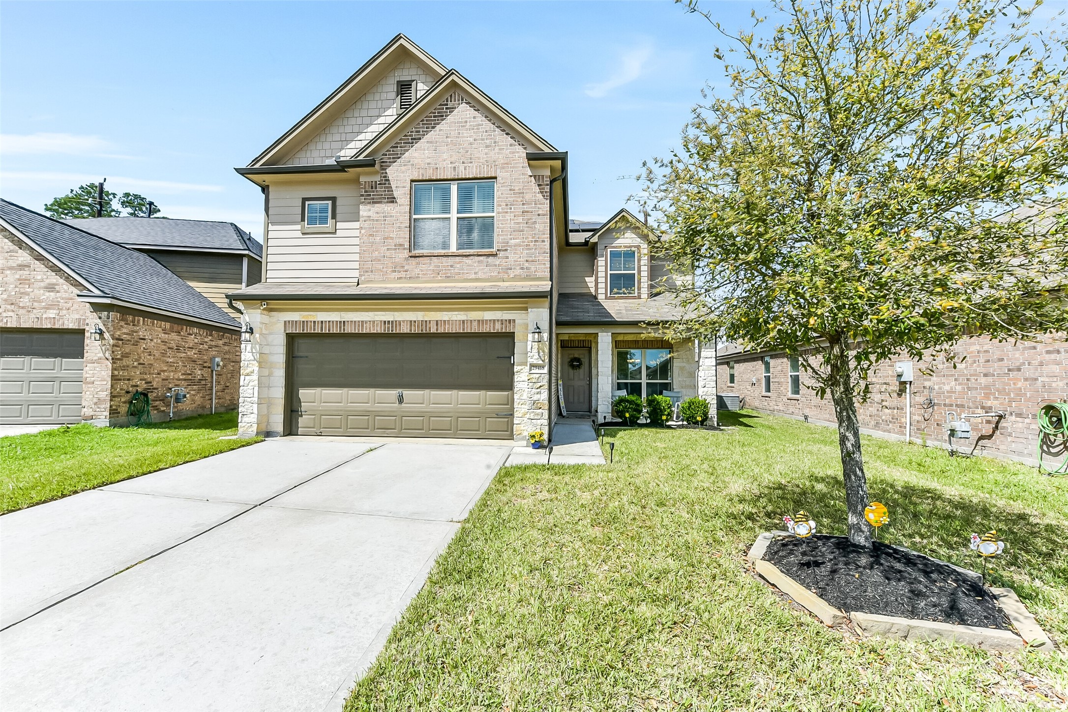 a front view of a house with a yard and garage