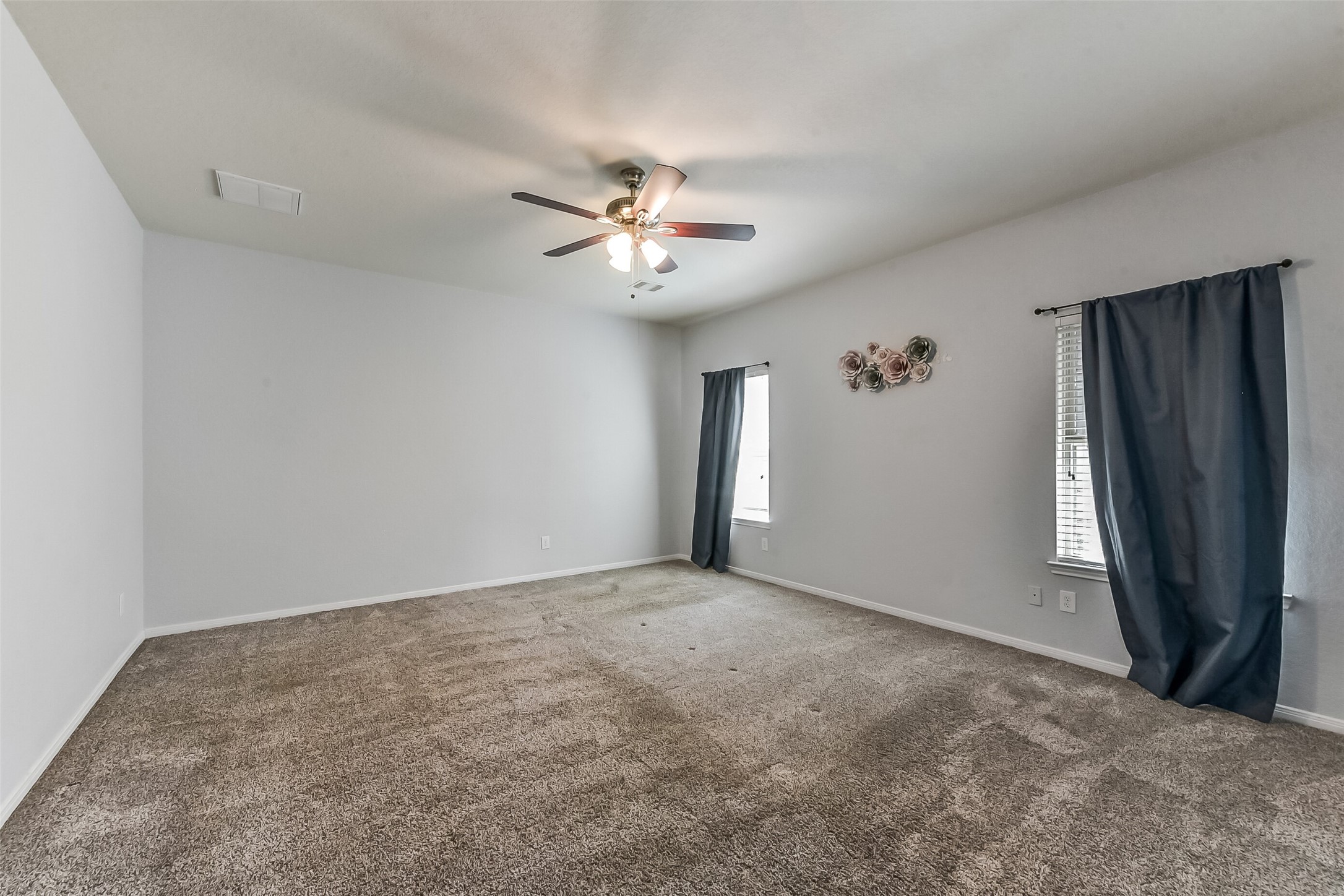 29418 Ridge Clearing Trail Spring, TX 77386 - Photo 14 of 37 an empty room with closet and a ceiling fan