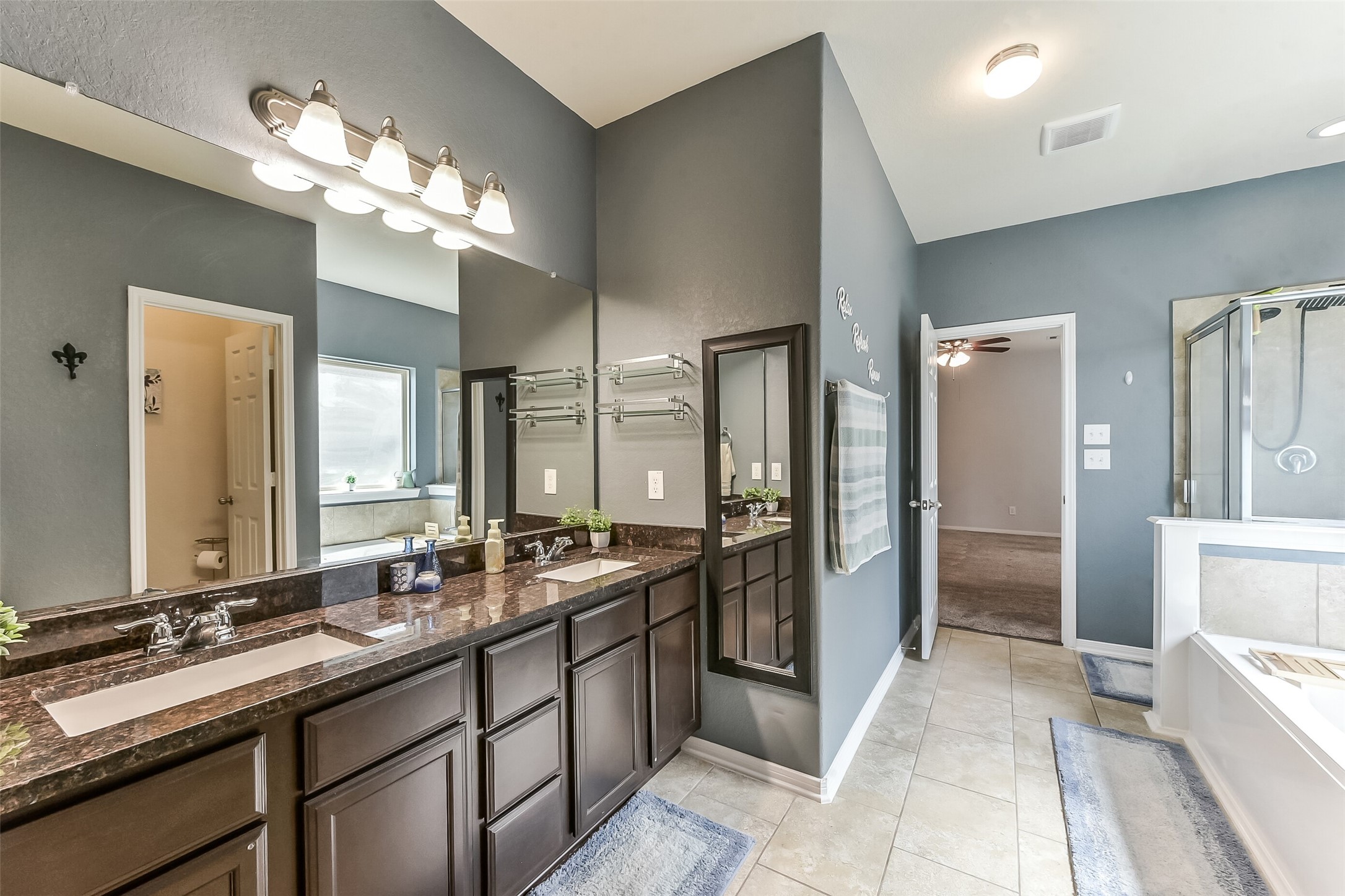 29418 Ridge Clearing Trail Spring, TX 77386 - Photo 17 of 37 a bathroom with a double vanity sink and a mirror