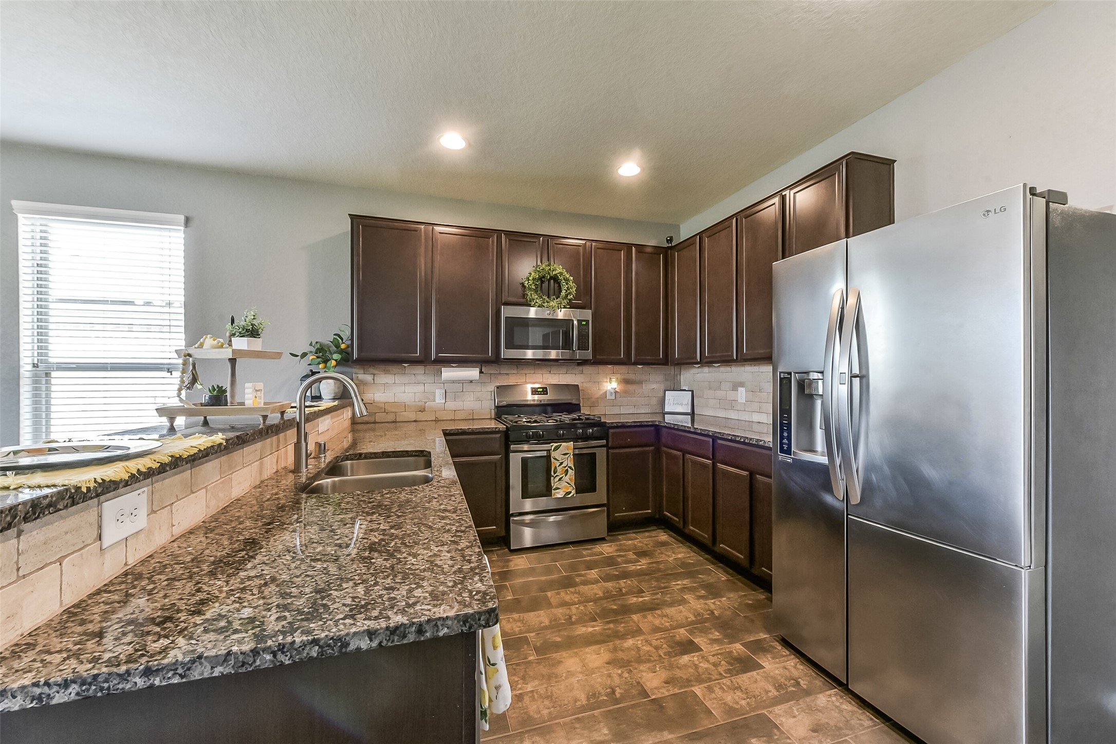 29418 Ridge Clearing Trail Spring, TX 77386 - Photo 8 of 37 a large kitchen with stainless steel appliances granite countertop a stove refrigerator and a sink