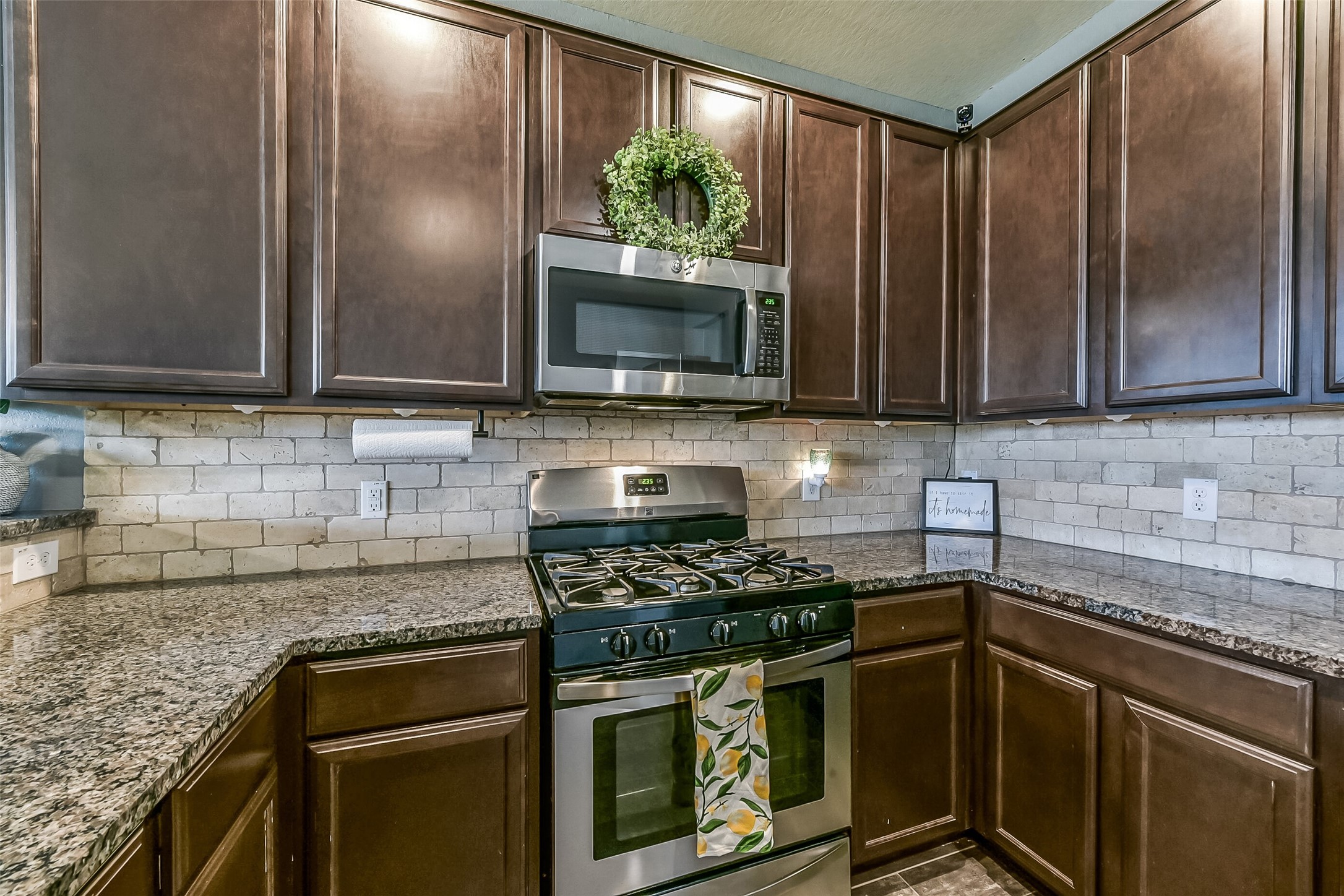29418 Ridge Clearing Trail Spring, TX 77386 - Photo 9 of 37 a kitchen with stainless steel appliances granite countertop wooden cabinets stove top oven and sink