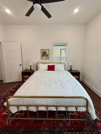 a bedroom with a large bed and a window