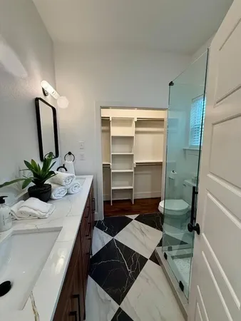 a bathroom with a sink toilet and shower