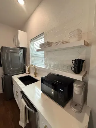 a kitchen with a sink a stove and a refrigerator